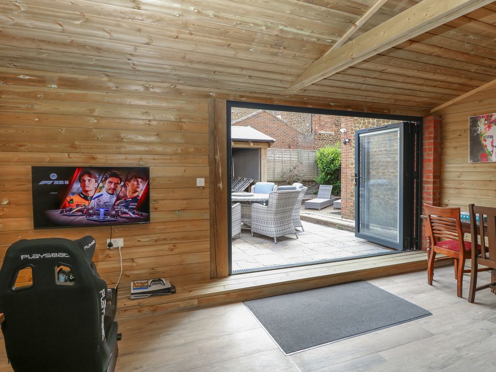 A snug with a gaming setup and outdoor access at The Burleigh in Hunstanton