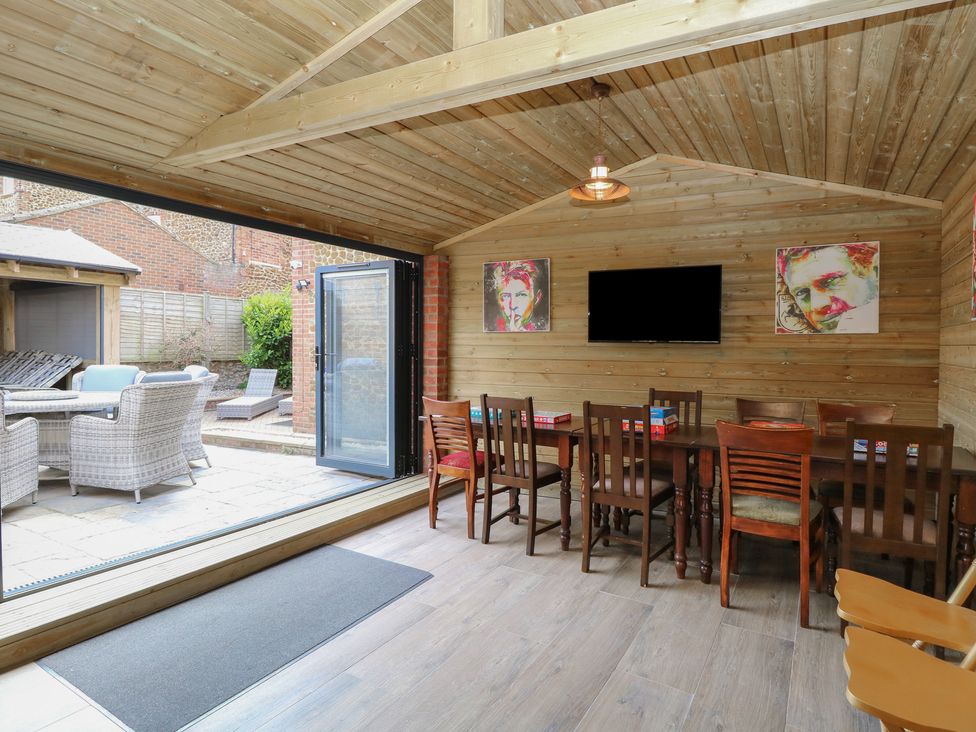 A dining room with a table and chairs at The Burleigh in Hunstanton