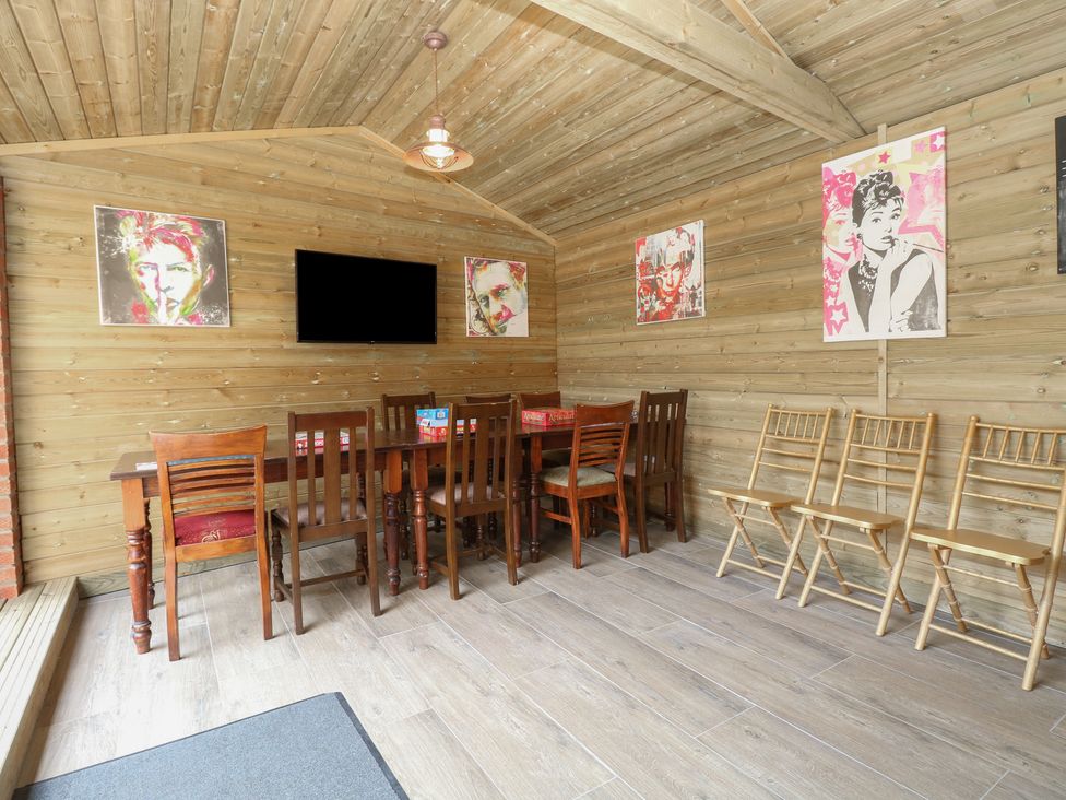 A dining room with a table and chairs at The Burleigh in Hunstanton