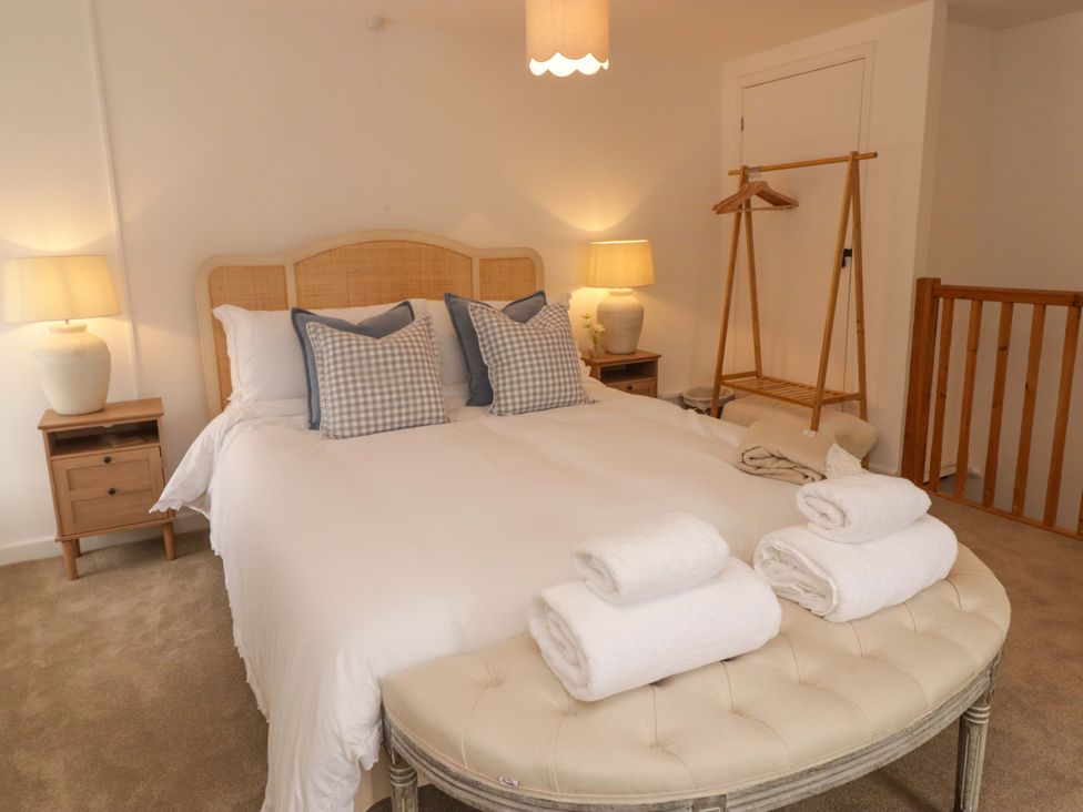 A bedroom with a bed and bedside tables at Penwyn in Solva