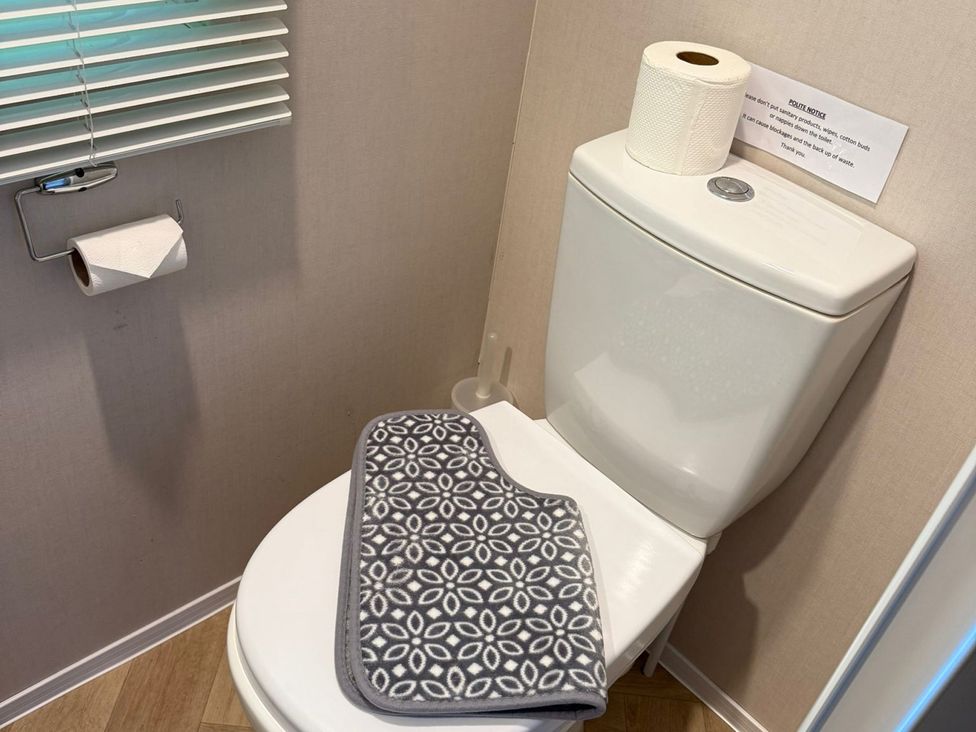 A bathroom with a toilet and toilet paper at Seren in Broughton, Cumbria