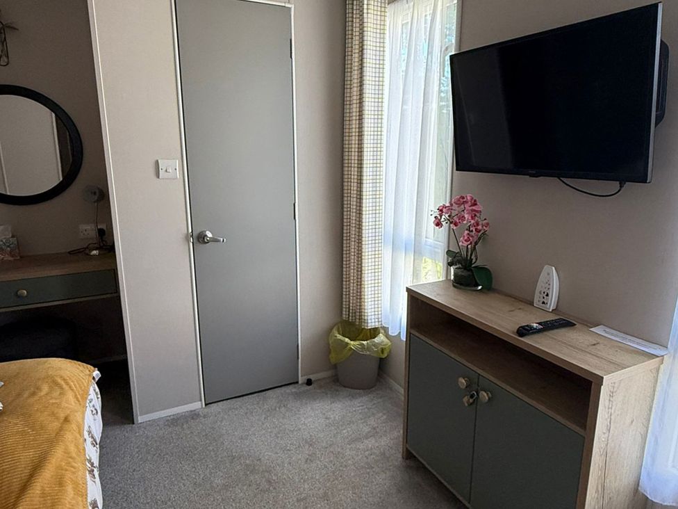 A bedroom with a TV and cabinet at Seren, Broughton, Cumbria