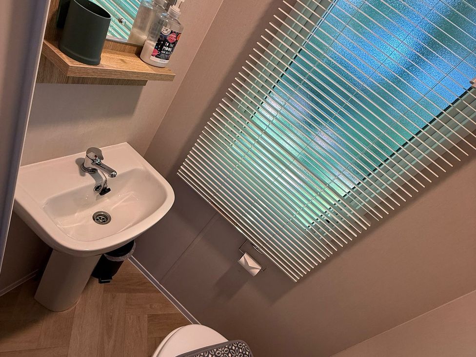 A bathroom with a washbasin and toilet at Seren, Broughton, Cumbria