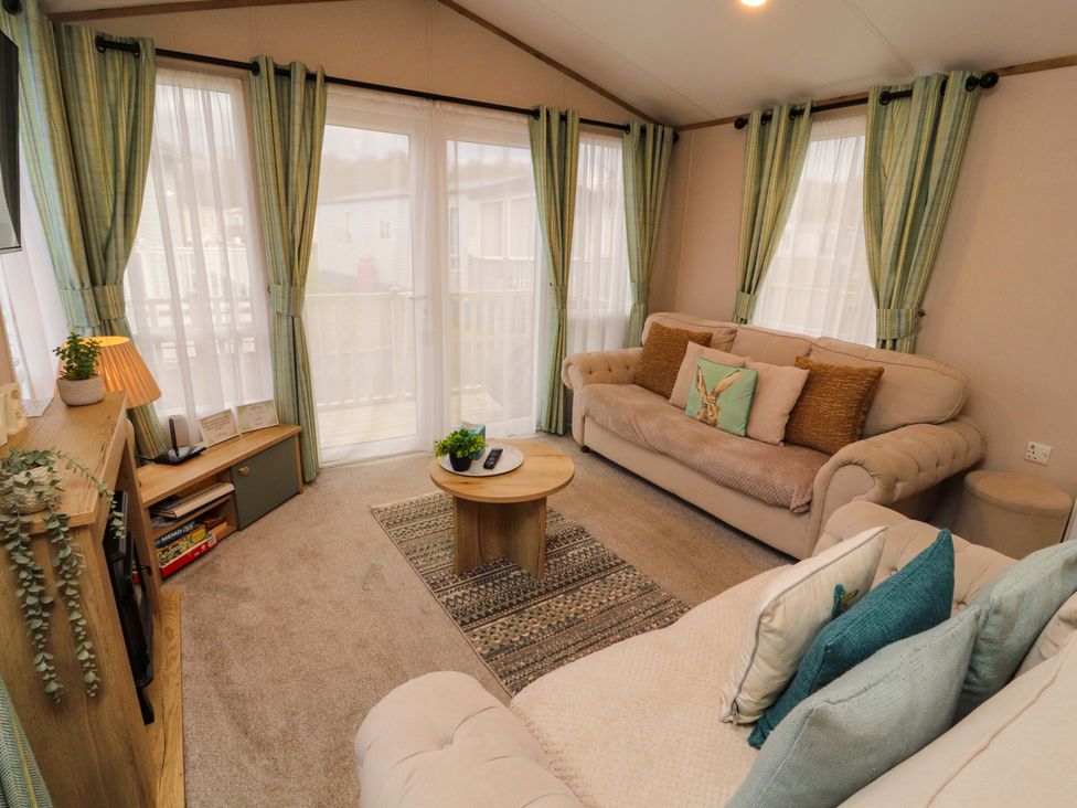 A living room with sofas and a coffee table at Seren in Broughton, Cumbria