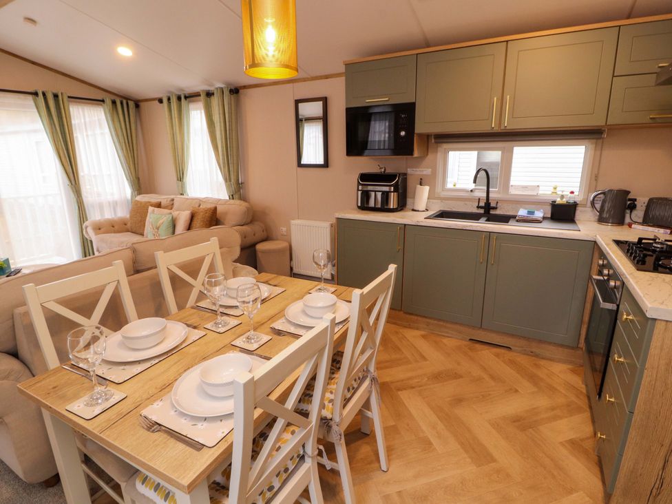 A kitchen with a dining area and living space at Seren in Broughton, Cumbria