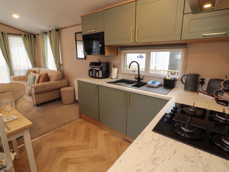 A kitchen with cabinets and appliances at Seren in Broughton, Cumbria