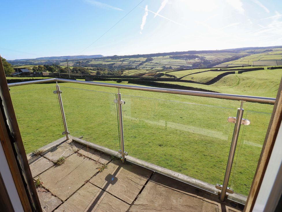 A balcony overlooking a grass landscape at 1 Flush House Lane Holmbridge