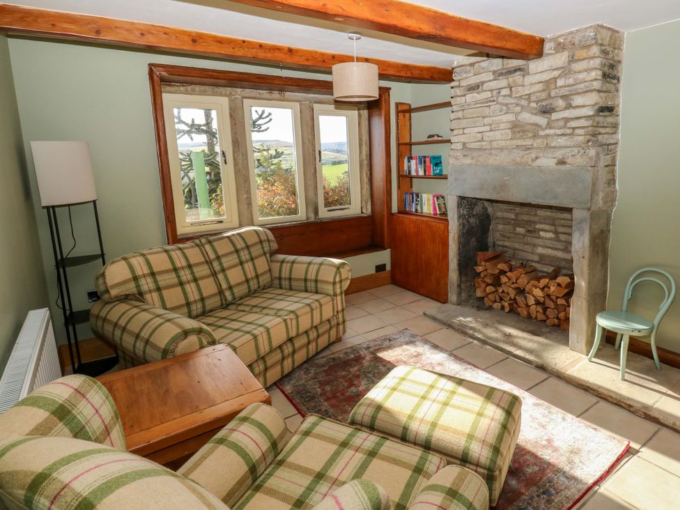 A snug with a sofa and armchair at 1 Flush House Lane in Holmbridge