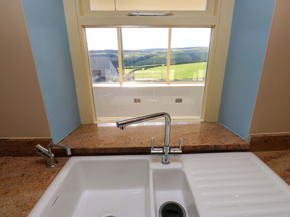 A kitchen sink with a view at 1 Flush House Lane in Holmbridge