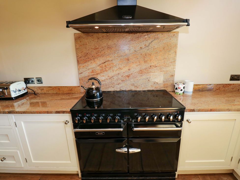A kitchen with a range cooker and kettle at 1 Flush House Lane Holmbridge