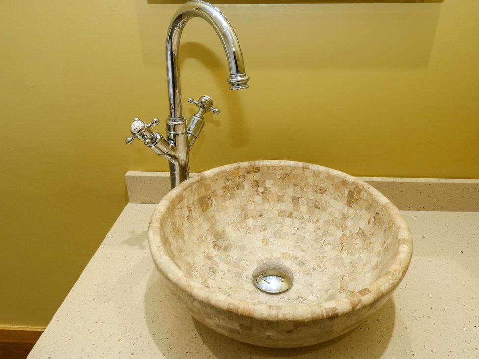 A sink and faucet on a countertop at 1 Flush House Lane Holmbridge