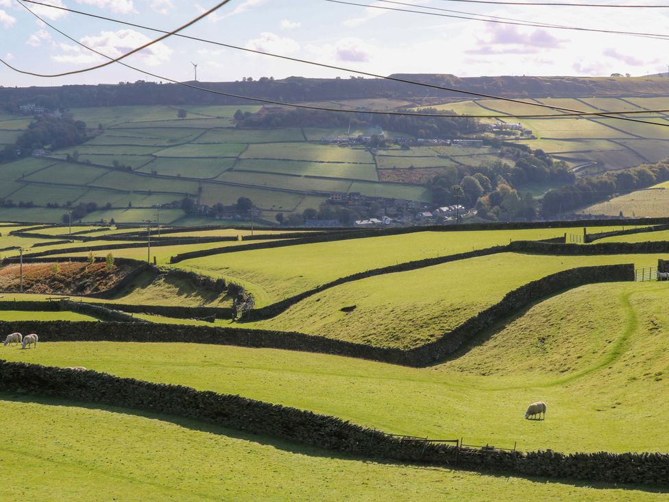 A landscape with sheep and fields at 1 Flush House Lane in Holmbridge
