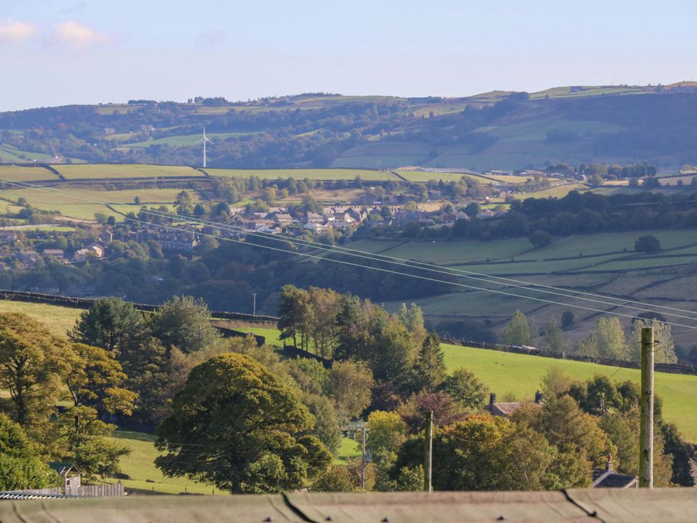 A view of hills and fields with houses at 1 Flush House Lane Holmbridge