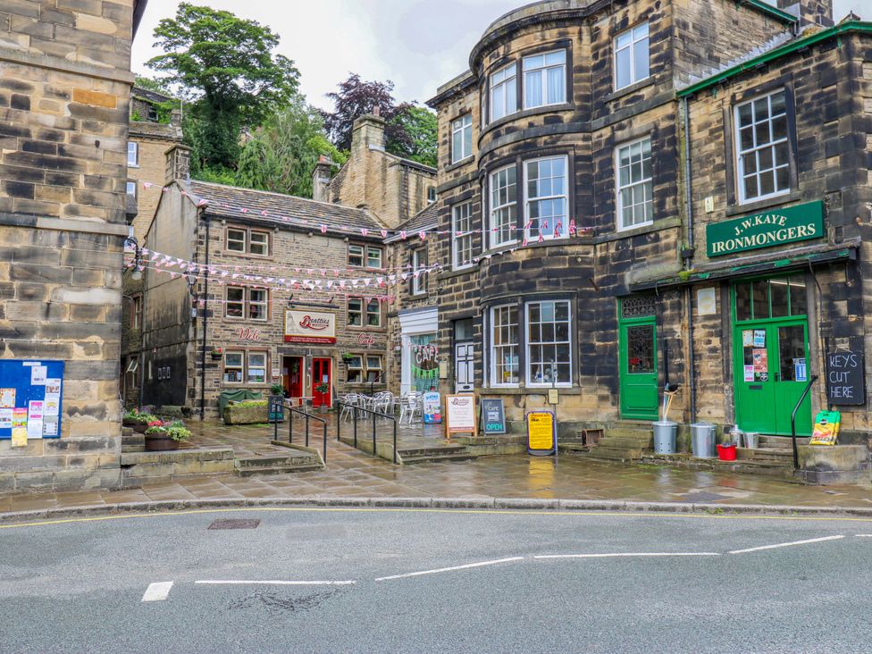 An outdoor street scene with shops and buildings at 1 Flush House Lane, Holmbridge
