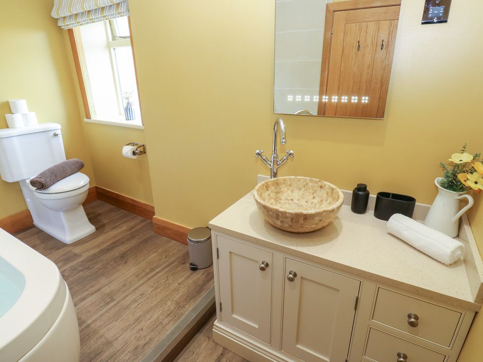 A bathroom with a sink and toilet at Stone & Fleece Cottage in Holmfirth