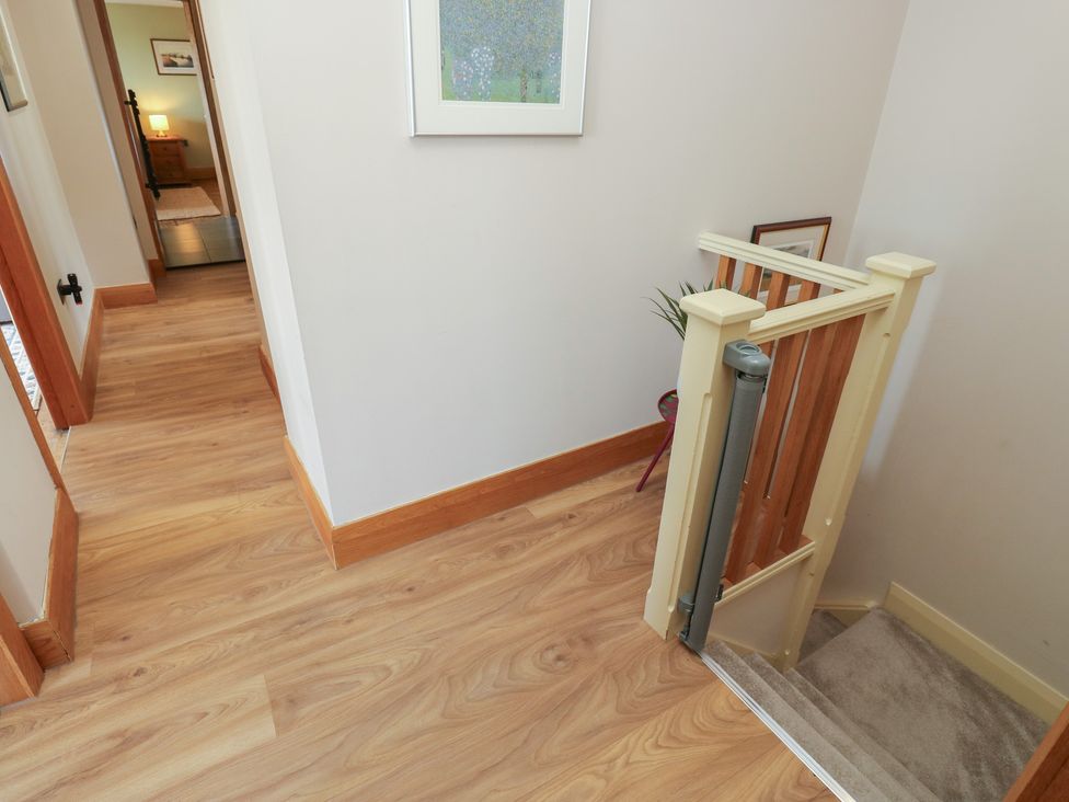 A hallway with stairs and door frames at Stone & Fleece Cottage in Holmfirth