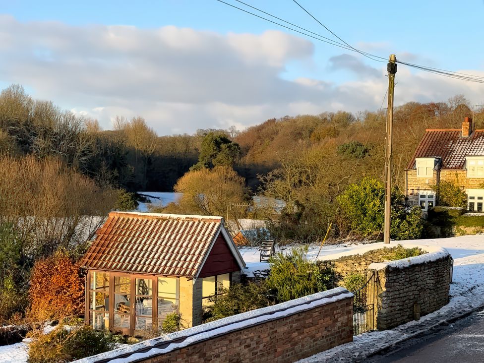 A greenhouse with snow in the garden at 32 Castlegate East Ayton