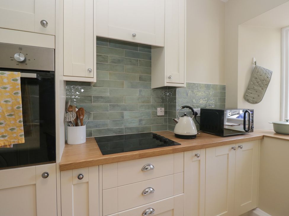 A kitchen with an oven, kettle, and toaster at The Barn at Grasmere