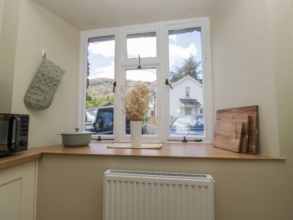 A kitchen with a vase on a windowsill at The Barn at Grasmere