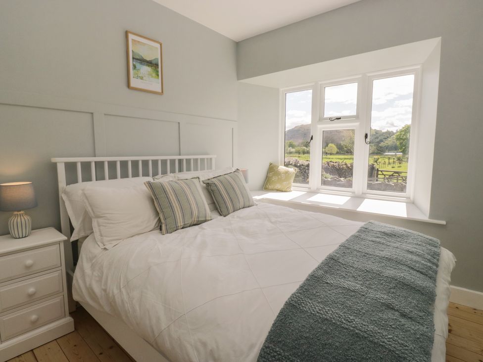 A bedroom with a bed and window at The Barn at Grasmere in Grasmere