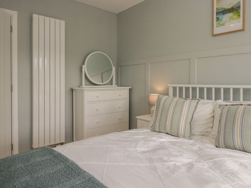A bedroom with a bed and dresser at The Barn at Grasmere