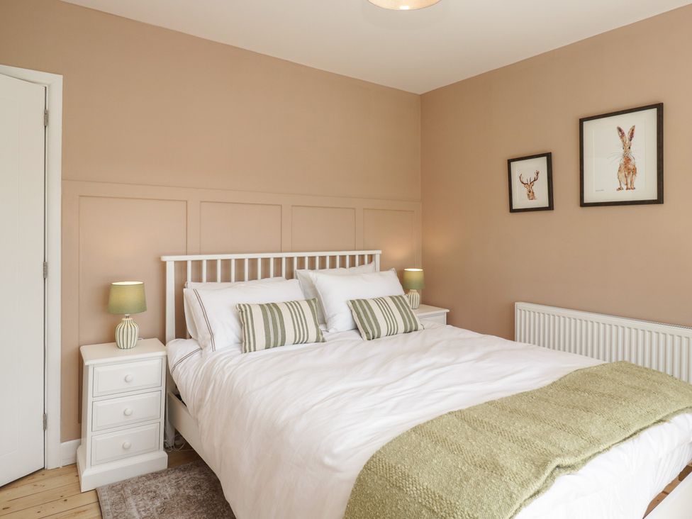 A bedroom with a bed and bedside table at The Barn at Grasmere