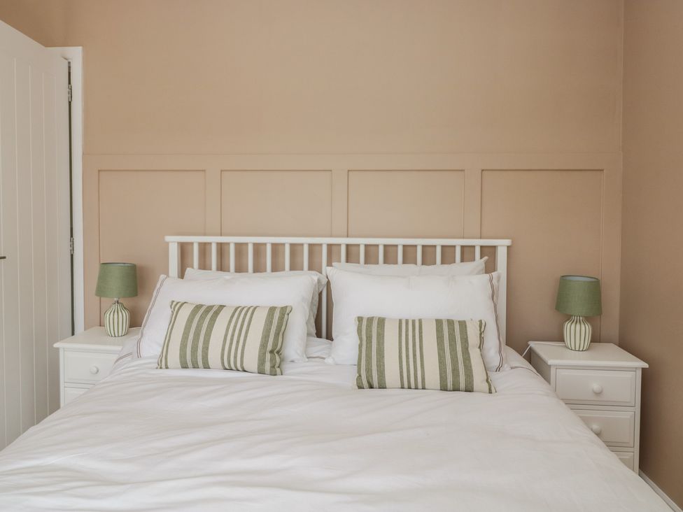 A bedroom with a bed and bedside tables at The Barn at Grasmere