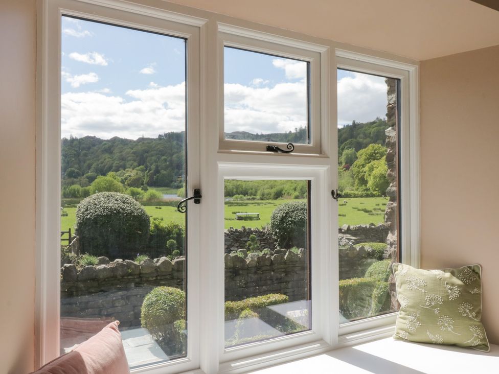 A view of a garden through windows at The Barn at Grasmere in Grasmere