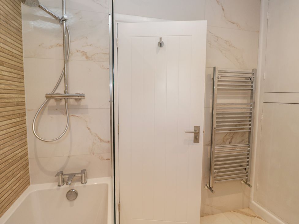 A bathroom with a shower and bathtub at The Barn at Grasmere
