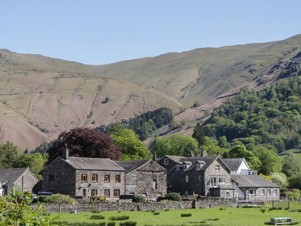 A landscape view of buildings and mountains at The Barn at Grasmere in Grasmere