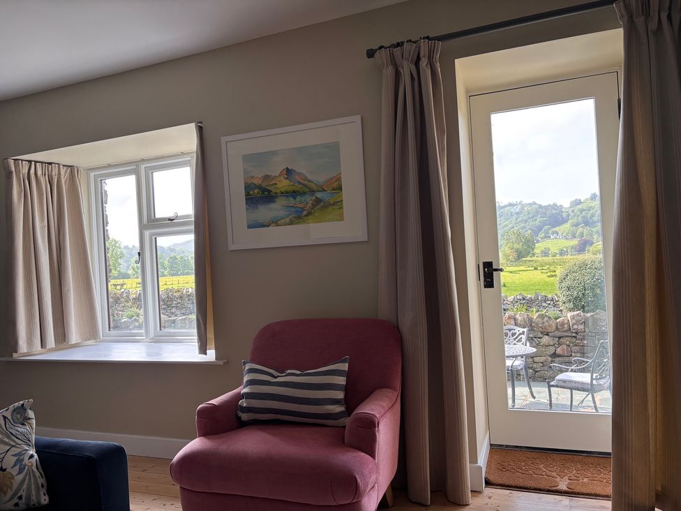 A living room with a view of a garden at The Barn at Grasmere in Grasmere