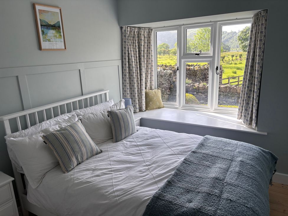 A bedroom with a bed and window at The Barn at Grasmere
