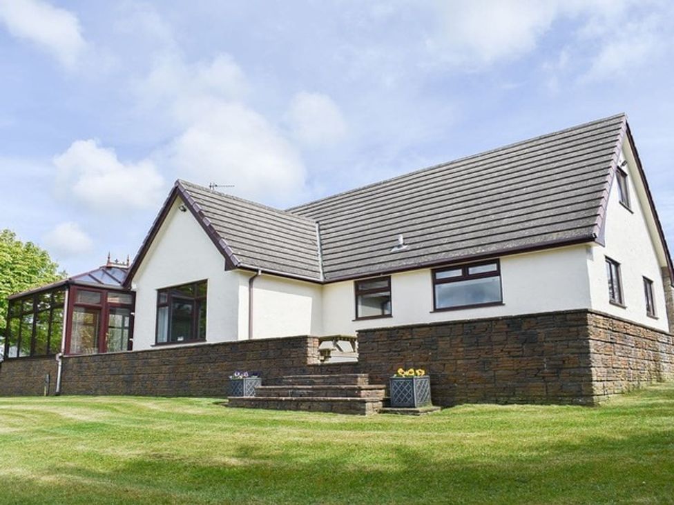 A house with a garden and steps at Cae Coch Brynteg near Benllech