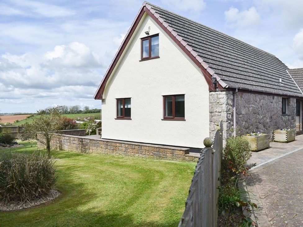 A house with a garden and pathway at Cae Coch in Brynteg near Benllech