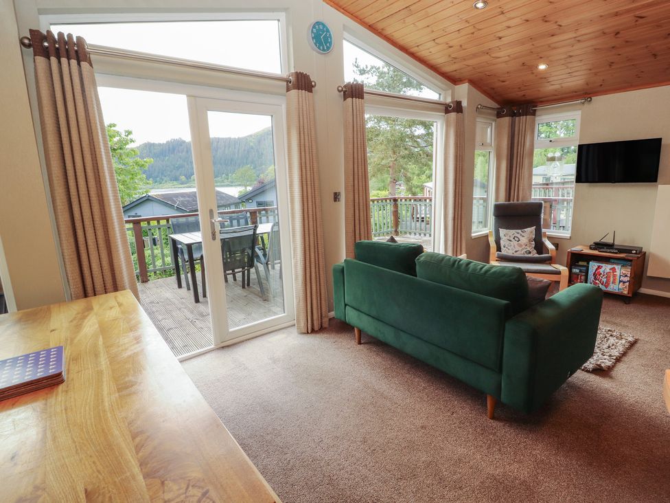 A living room with a sofa and television at 28 Troutbeck in Bassenthwaite