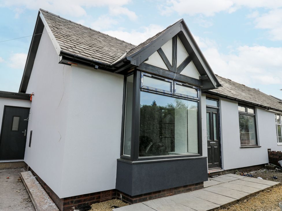 An exterior view of a house with a pathway at 489 New Hey Road Huddersfield