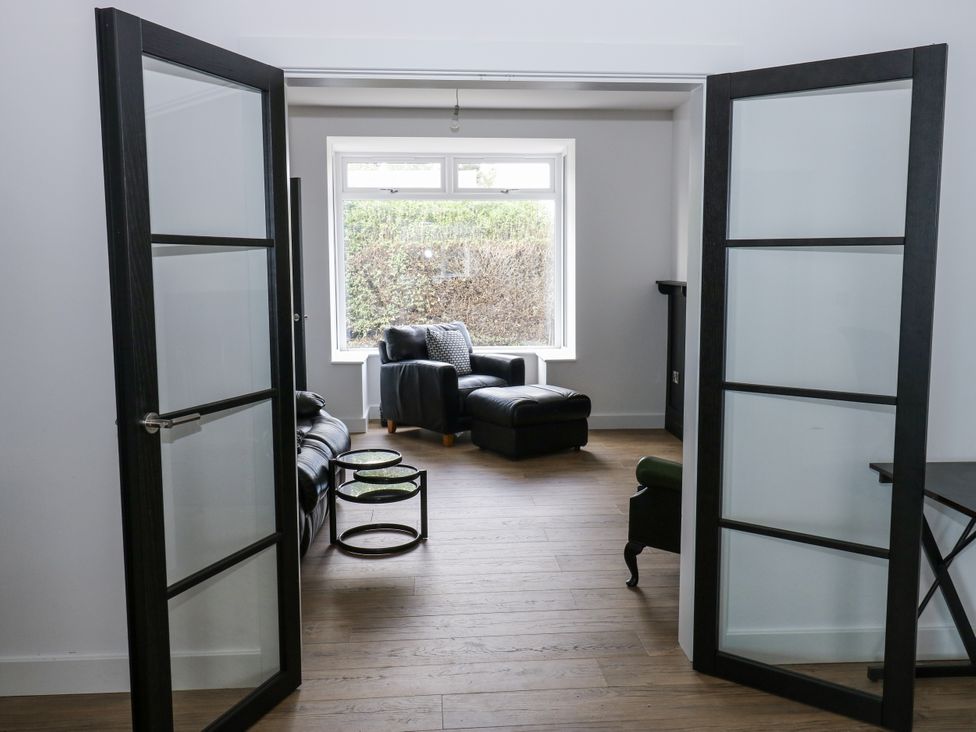 A living room with a sofa and coffee table at 489 New Hey Road in Huddersfield