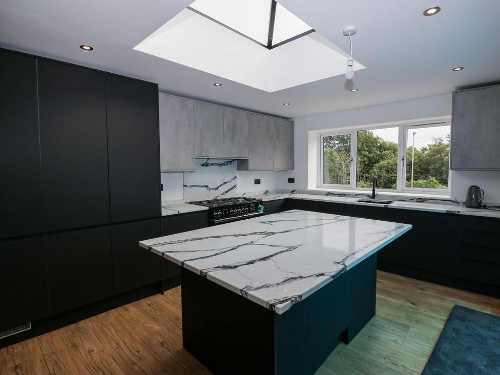 A kitchen with a marble countertop and modern appliances at 489 New Hey Road in Huddersfield