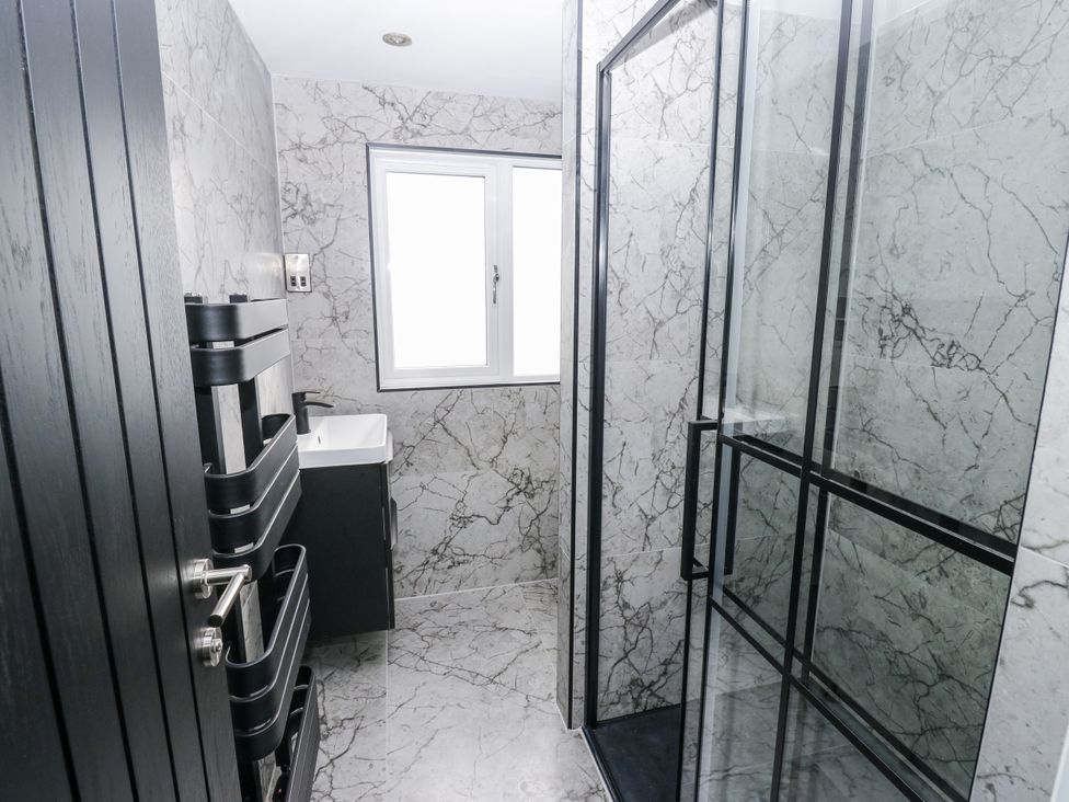 A bathroom with a sink and shower at 489 New Hey Road in Huddersfield