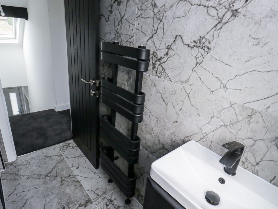 A bathroom with a towel radiator and sink at 489 New Hey Road in Huddersfield
