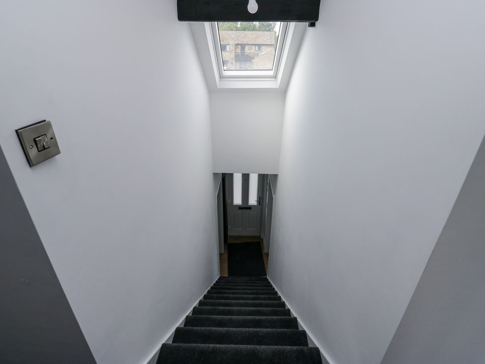 Stairs leading down with a door at the bottom at 489 New Hey Road in Huddersfield
