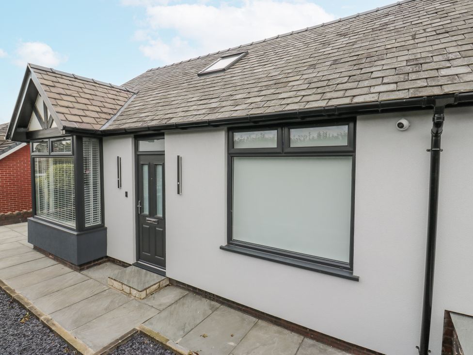 The exterior of a residential property with an entrance and windows at Ellis House in Huddersfield