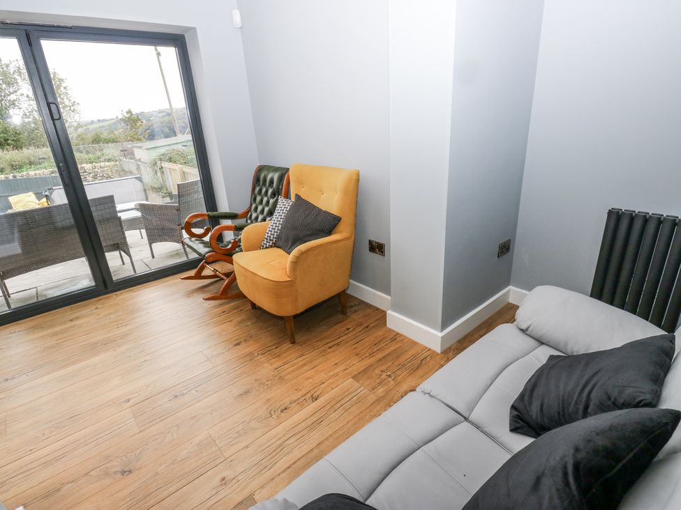 A snug with a sofa and chair at Ellis House in Huddersfield