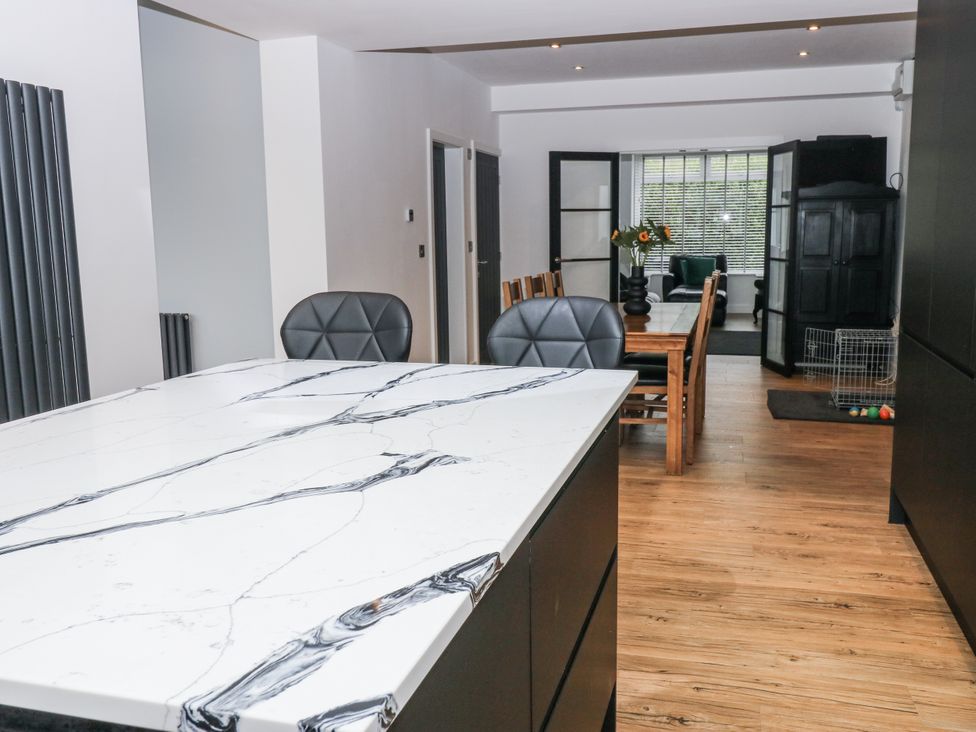 A kitchen with an island and dining area at Ellis House in Huddersfield
