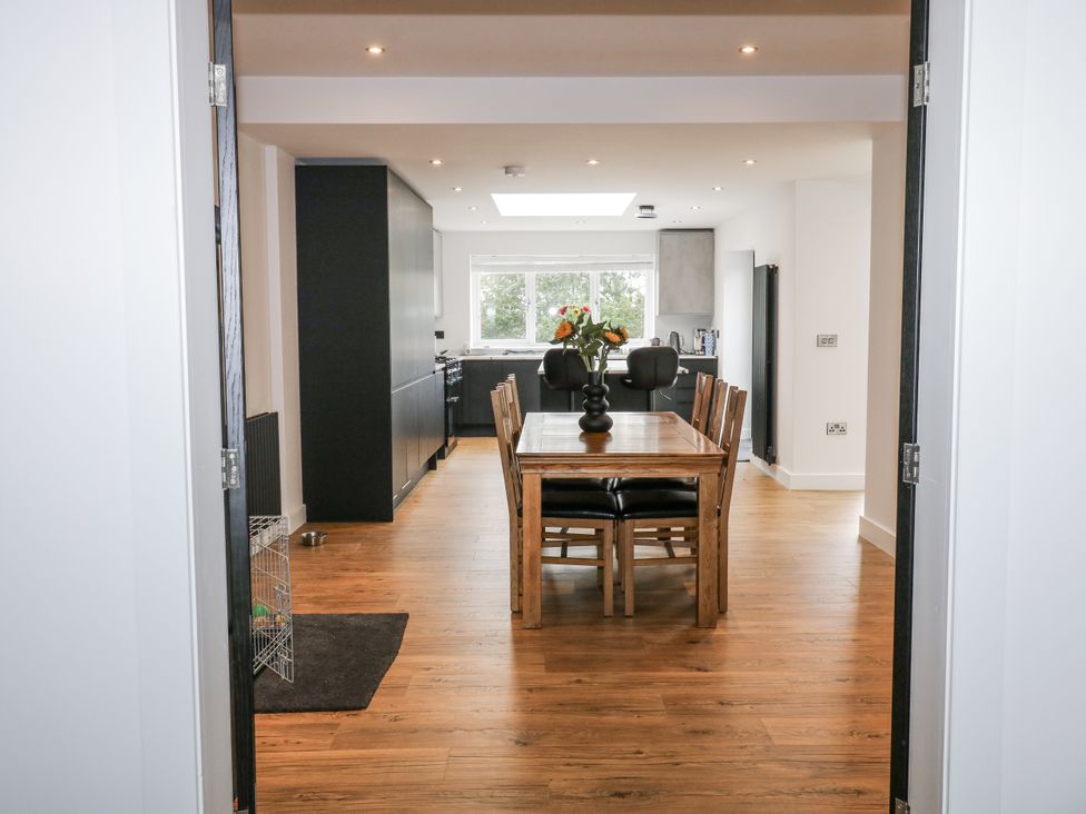 A dining room with a wooden table and chairs at Ellis House in Huddersfield