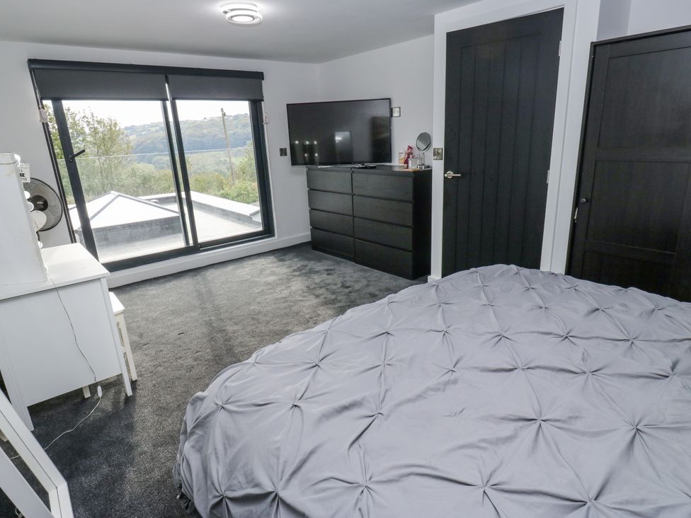 A bedroom with a television and a bed at Ellis House in Huddersfield