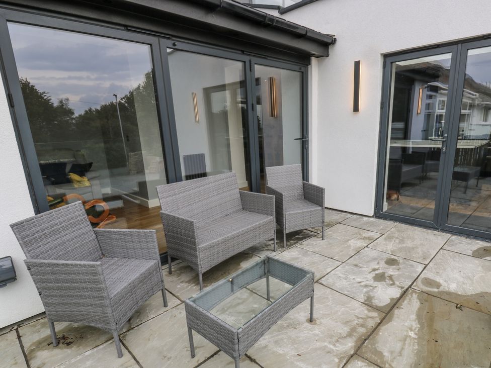 An outdoor patio with chairs and a table at Ellis House in Huddersfield