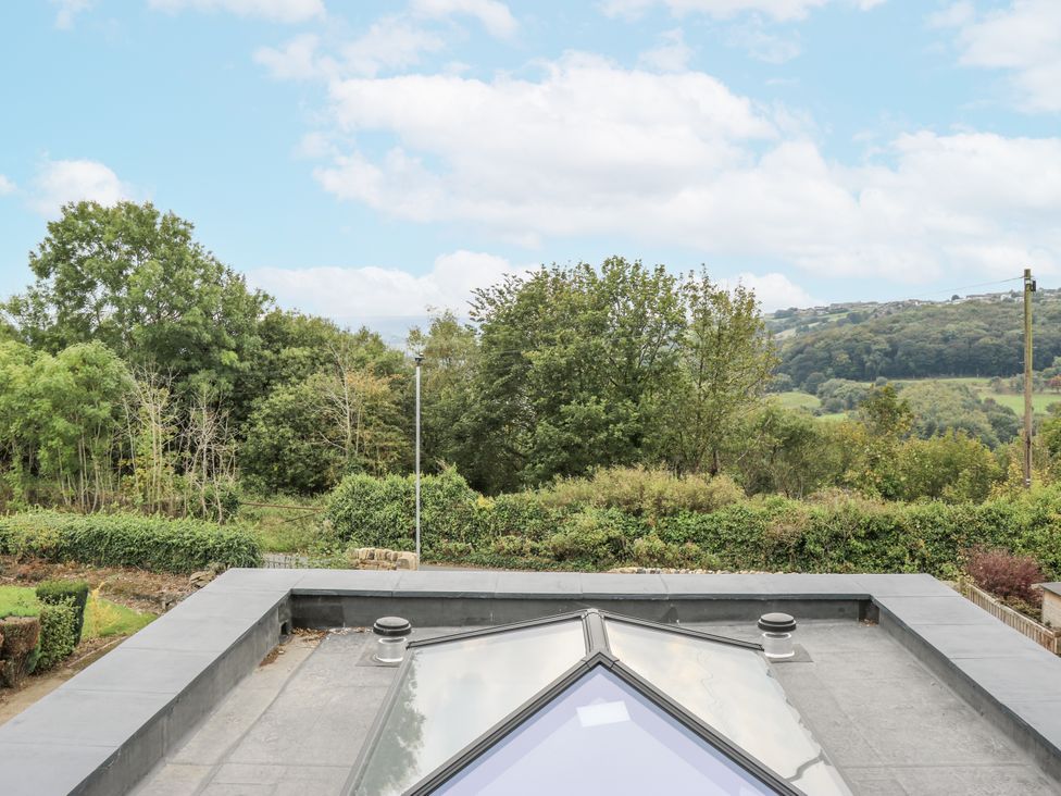 A view of trees and hills from a rooftop at Ellis House in Huddersfield