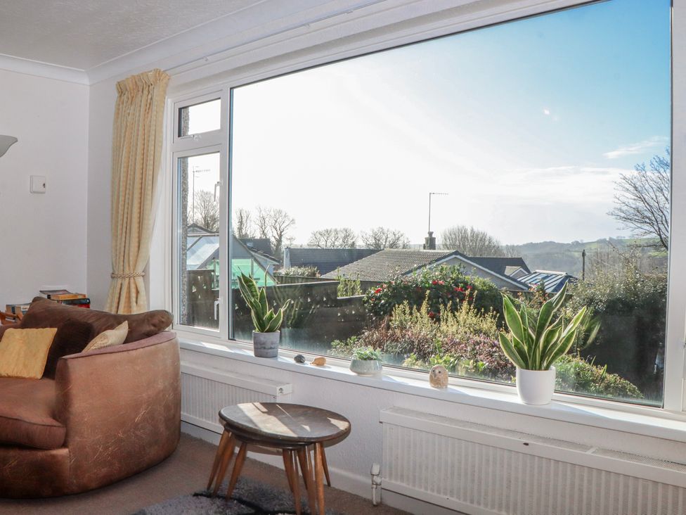 A living room with a large window and view at 7 Erme Drive in Ivybridge