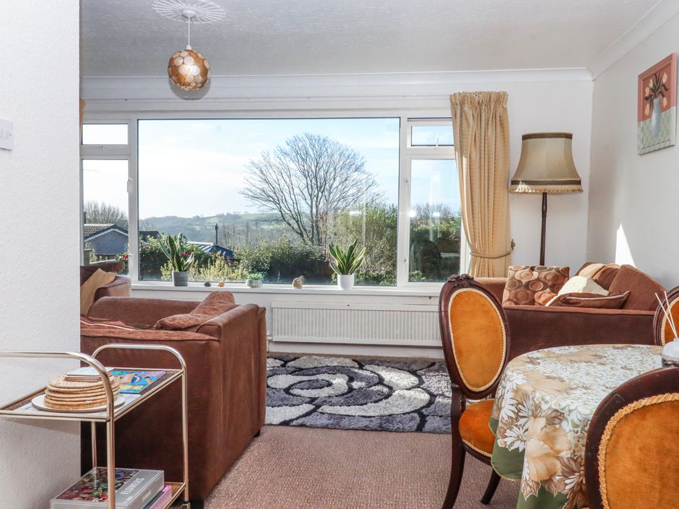 A living room with a sofa and a view at 7 Erme Drive in Ivybridge